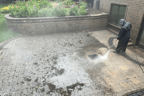 Patio Pavers Caked in Mud and Grime Are Washed Away by a GrimeBusters Soft Wash and Holiday Lighting Team Member.