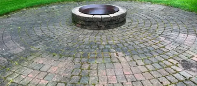 A Dirty Section of Patio Pavers Lay Around a Fireplace of a Pittsburgh Home.